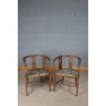 Pair of Edwardian elbow chairs, the curved top rail above three oval pierced boxwood strung