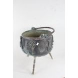 20th century copper and brass cauldron, with swing handle, the body applied with various brass