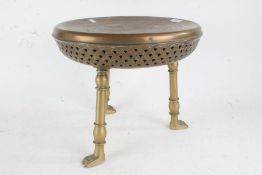 Turkish brass foot warming stool, the stool centred with incised decoration of animals, raised on