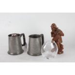 Two golfing related pewter tankards, a black forest style wooden figure of an elderly gentleman