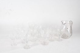 Suite of eight wine glasses with slice cut decoration, matching set of seven liqueur glasses,