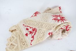 Mixed textiles, to include a lace and linen table cloth with red floral embroidery, three other lace