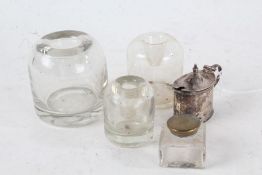 Three Victorian glass circular ink bottles, and a square inkwell smaller, and an early 20th