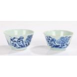 Pair of Chinese tea bowls, Qing dynasty, each circular bowl painted with flowers in blue on a