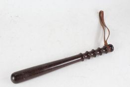 Lignum vitae truncheon, with brown leather strap, 37.5cm long