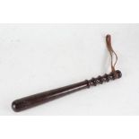 Lignum vitae truncheon, with brown leather strap, 37.5cm long