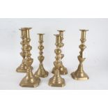 Three pairs of 19th century brass candlesticks, each of the same form with knopped columns and