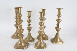 Three pairs of 19th century brass candlesticks, each of the same form with knopped columns and