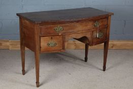 Edwardian mahogany bow front side table, the reeded frieze above a single long drawer and two