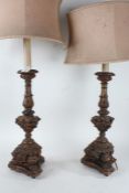 Pair of Rococo style carved gilded wooden table lamps, the semi-circular shades above an acanthus