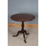 George III style oak tilt-top table, the circular top raised on a turned stem with tripod legs and