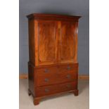 George III mahogany converted linen cupboard, the moulded cornice above a pair of panelled doors