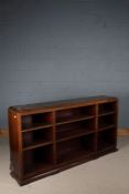 Mahogany open bookcase, with down-swept pediment and open recesses, on a plinth base, 180cm wide