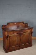 Victorian mahogany chiffonier, the scroll carved upstand above two panelled cupboard doors opening