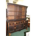 19th century oak and pine dresser, the associated top with two shelves, the base fitted two long