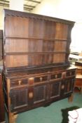 19th century oak and pine dresser, the associated top with two shelves, the base fitted two long