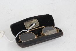 Pair of yellow metal spectacles, housed in a case