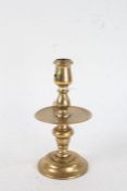 Dutch Heemskerk style brass candlestick, the shaped sconce above central drip tray, on a domed foot,