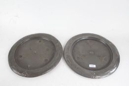 Pair of Art Nouveau pewter chargers, with foliate and scroll decorated central fields and borders,