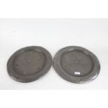 Pair of Art Nouveau pewter chargers, with foliate and scroll decorated central fields and borders,