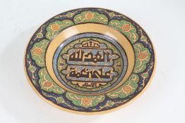 Middle Eastern earthenware dish, the central field with Islamic script and scroll decorated