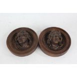 Pair of 19th century carved roundels, depicting a male and female head, 17.5cm diameter (2)