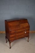 Edwardian mahogany bureau, the quarter veneered fall opening to reveal small drawer and pigeonholes,