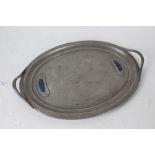Arts and Crafts enamel mounted beaten pewter serving tray, of oval form with pierced carrying
