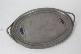 Arts and Crafts enamel mounted beaten pewter serving tray, of oval form with pierced carrying