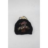 Evening bag with ivory effect plastic clasp above a floral basket embroidered body, beadwork