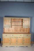 Modern stripped pine and green painted dresser, the upper section having a pair of cupboards with