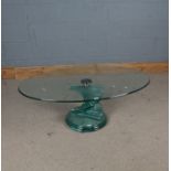 Modern glass coffee table, the oval top above a stepped spiral column, 119cm wide, 40cm high