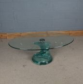 Modern glass coffee table, the oval top above a stepped spiral column, 119cm wide, 40cm high