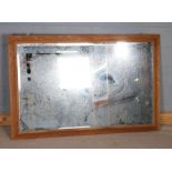 Large oak framed wall mirror, with a bevelled glass plate, 108cm x 165cm