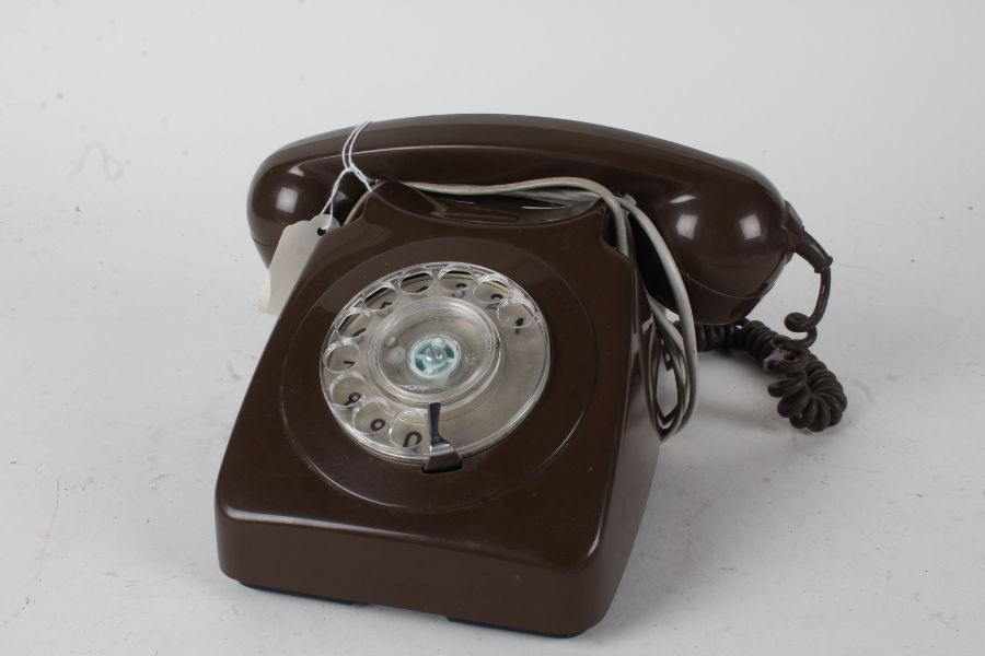 Brown plastic rotary dial telephone, 24cm wide