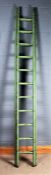 Green painted extending wooden ladder, 273cm long not extended