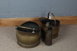 Two brass coal scuttles, together with a WW2 brass shell case dated 1941 and a pair of fire tongs (