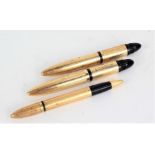Two Sheaffer's 14 carat gold filled fountain pens, each 10cm long and a similar propelling pencil (