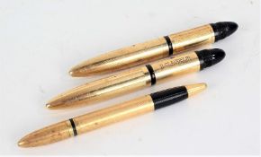 Two Sheaffer's 14 carat gold filled fountain pens, each 10cm long and a similar propelling pencil (