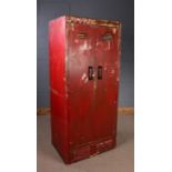 20th Century industrial steel cabinet, painted in red, the pair of vented hinged doors enclosing