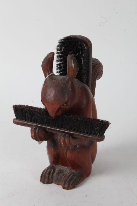 Novelty carved wooden brush stand, in the form of a squirrel, 24cm high