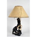 20th Century ebonised reading lamp, formed as an elephant besides a tree trunk, 49cm high