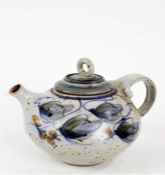 Art pottery teapot, the loop handle above a foliate decorated boy, stamped indistinctly to foot,