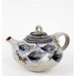 Art pottery teapot, the loop handle above a foliate decorated boy, stamped indistinctly to foot,