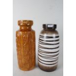 Two west German vases one of dark stripe colourings the other of orange and a onion like design 41cm