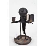 Metal smokers companion stand, modelled as a butler holding a matchbox holder and candle sconce, his