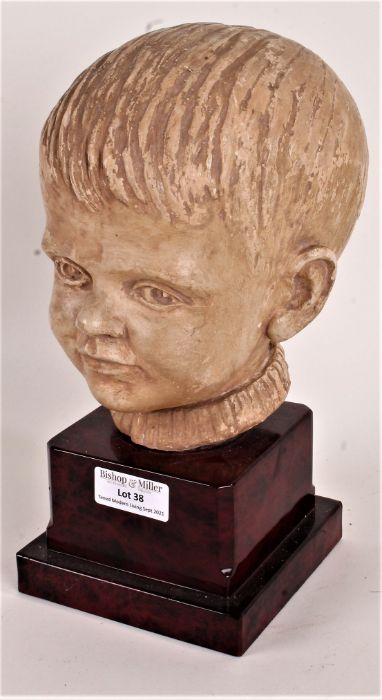 Art Deco style pottery bust, in the form of a boy, raised on a marble effect plinth, 23.5cm high