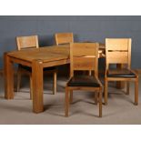 Light oak dining table, the rectangular top above four darker square legs, together with four