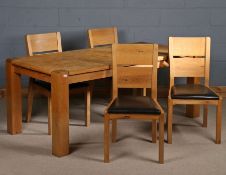 Light oak dining table, the rectangular top above four darker square legs, together with four