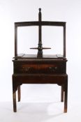 19th Century oak and elm clothes press, the screw thread top above the turned handles and press